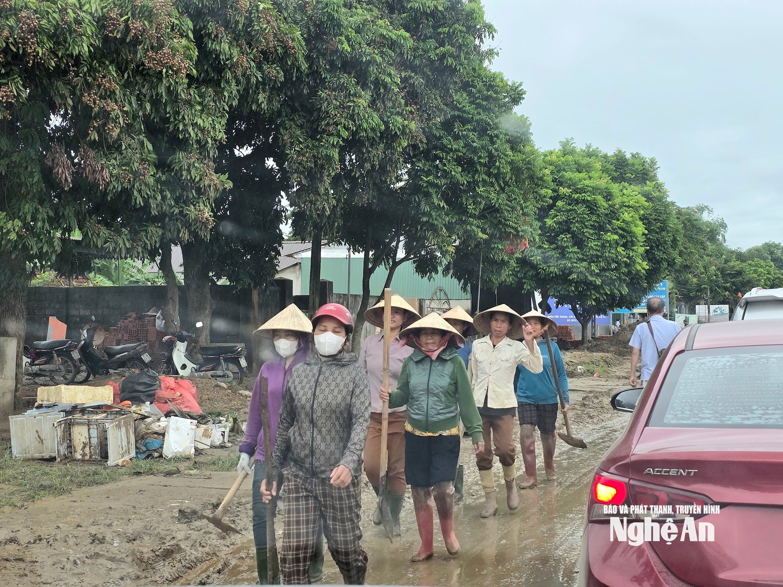 Người dân các bản ở xã Châu Khê đến giúp người dân thôn Tiến Thành, xã Con Cuông khắc phục hậu quả lũ lụt. Ảnh: Hoài Thu